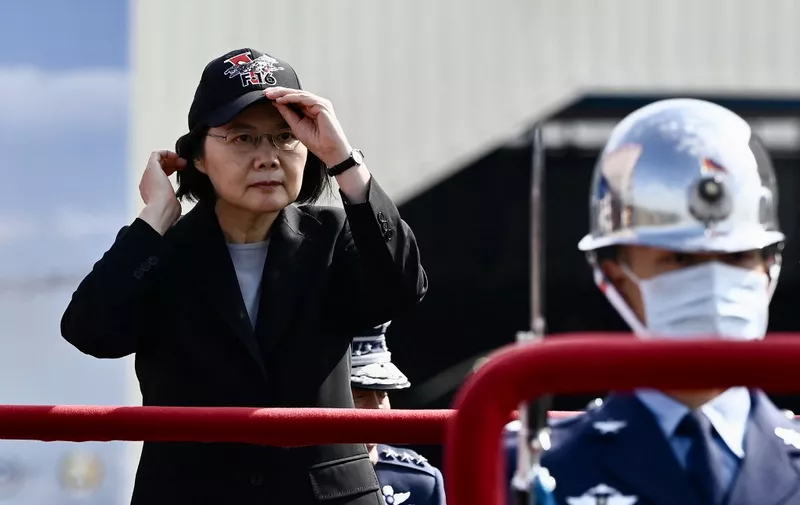 Taiwan President Tsai Ing-wen adjusts her cap during a ceremony at the Chiayi Air Force in southern Taiwan on November 18, 2021. (Photo by Sam Yeh / AFP)