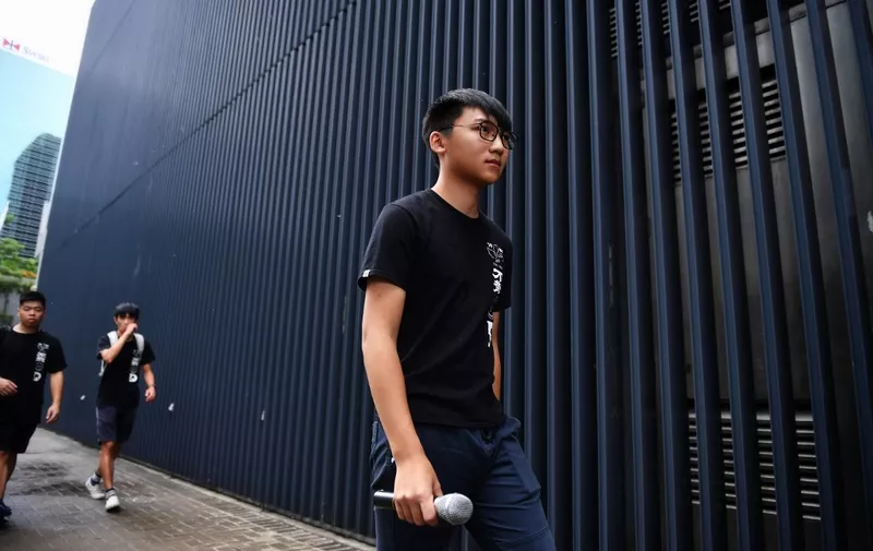 Demosisto vice chairperson Isaac Cheng arrives with fellow members to a press conference on the arrest of party leaders Joshua Wong and Agnes Chow, in Hong Kong on August 30, 2019. - Prominent Hong Kong democracy activists were arrested August 30 in a dragnet that came as protesters planned to rally this weekend in defiance of a police ban. (Photo by Lillian SUWANRUMPHA / AFP)