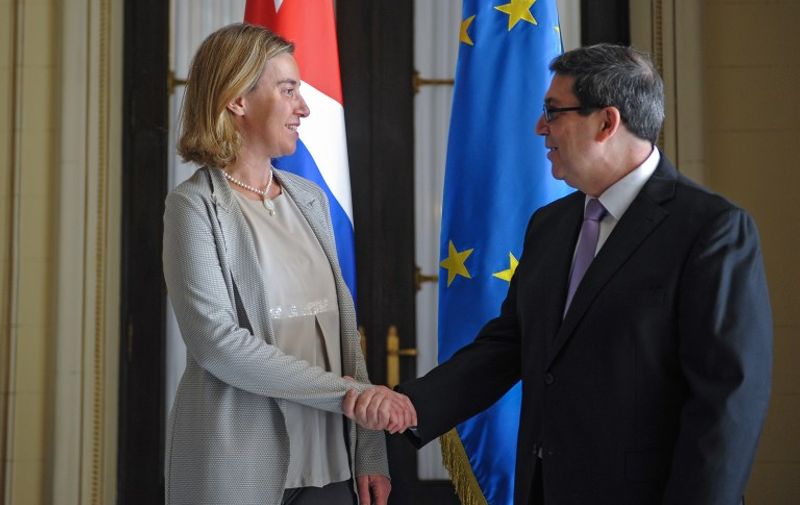 High Representative of the European Union for Foreign Affairs and Security Policy and Vice-President of the European Commission in the Juncker Commission, Federica Mogherini (L), shakes hands with Cuban Minister of Foreign Affairs Bruno Rodriguez at the Foreign Affairs Ministry in Havana, on March 11, 2016. The EU and Cuba signed a deal Friday to normalize relations, including a deal on the delicate issue of human rights -- a breakthrough just ahead of US President Barack Obama's historic visit to the island. EU and Cuban officials signed the agreement, the culmination of nearly two years of intense negotiations, during a visit to Havana by European foreign policy chief Federica Mogherini.      AFP PHOTO/YAMIL LAGE / AFP / YAMIL LAGE