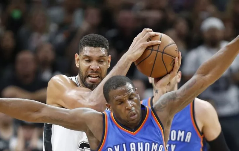 SAN ANTONIO,TX - APRIL 12:Tim Duncan #21 of the San Antonio Spurs grabs a rebound in front of Dion Waiters #3 of the Oklahoma City Thunder at AT&amp;T Center on April 12, 2016 in San Antonio, Texas. NOTE TO USER: User expressly acknowledges and agrees that , by downloading and or using this photograph, User is consenting to the terms and conditions of the Getty Images License Agreement.   Ronald Cortes/Getty Images/AFP