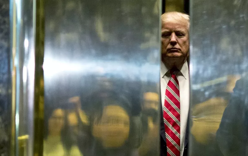 (FILES) In this file photo taken on January 16, 2017, US President-elect Donald Trump boards the elevator after escorting Martin Luther King III to the lobby after meetings at Trump Tower in New York City. - Incumbent US President Donald Trump has been denied a second term after challenger, former US Vice President Joe Biden won the election, TV networks projected on November 7, 2020, a victory sealed after the Democrat claimed several key battleground states won by the Republican incumbent in 2016. CNN, NBC News and CBS News called the race in his favor, after projecting he had won the decisive state of Pennsylvania. His running mate, US Senator Kamala Harris, has become the first woman US Vice President elected to the office. (Photo by DOMINICK REUTER / AFP)