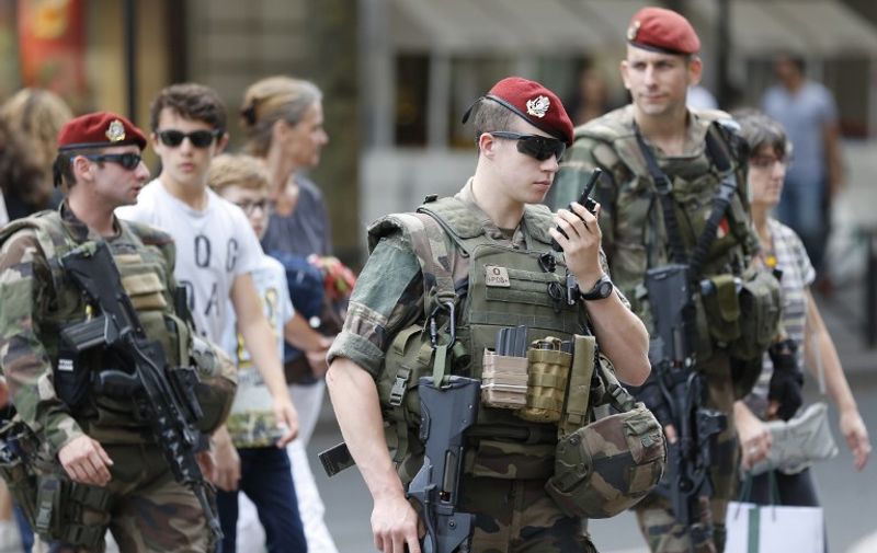 French soldiers, part of "Operation Vigipirate", patrol near the Galeries Lafayette in Paris on July 15, 2016, a day after the attack in Nice.
A Tunisian-born man zigzagged a truck through a crowd celebrating Bastille Day in the French city of Nice, killing at least 84 and injuring dozens of children in what President Francois Hollande on July 15 called a "terrorist" attack. / AFP PHOTO / MATTHIEU ALEXANDRE