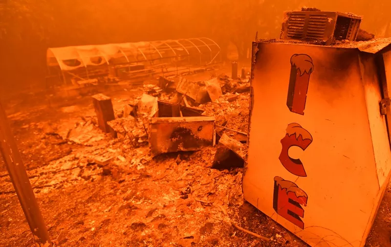 A singed ice machine sits over a burned store during the Bear fire, part of the North Lightning Complex fires, in unincorporated Butte County, California on September 09, 2020. - Dangerous dry winds whipped up California's record-breaking wildfires and ignited new blazes Tuesday, as hundreds were evacuated by helicopter and tens of thousands were plunged into darkness by power outages across the western United States. (Photo by JOSH EDELSON / AFP)