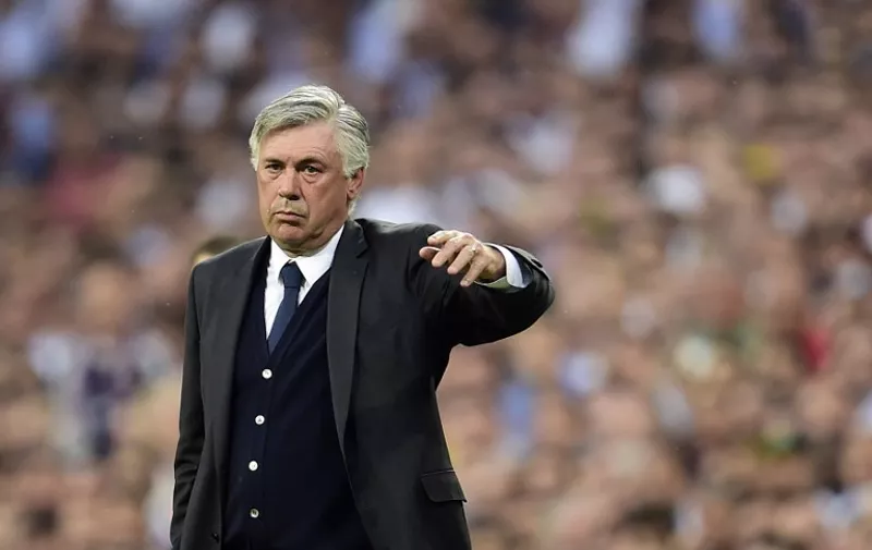 Real Madrid's Italian coach Carlo Ancelotti gestures during the UEFA Champions League semi-final second leg football match Real Madrid FC vs Juventus at the Santiago Bernabeu stadium in Madrid on May 13, 2015.   AFP PHOTO/ GERARD JULIEN