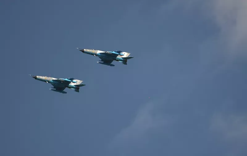 Two MIG 21 airplane fly over Mihail Kogalniceanu 57 Air Base near Constanta, Romania on August 2, 2018. - A British detachment of about 160 soldiers (pilots and technical staff) runs from May 1st to August 31th, fourfold airforce missions reinforced by four Eurofighter Typhoon aircraft, alongside the MiG-21 LanceR and Romanian Air Force soldiers. (Photo by Daniel MIHAILESCU / AFP)