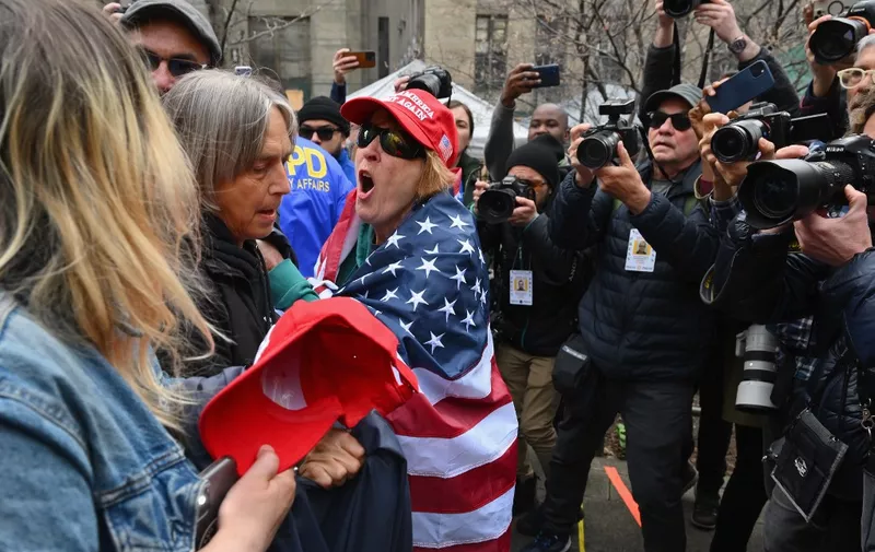 Pro and anti trump supporters face off during a protest outside of Manhattan Criminal Court in New York City on April 4, 2023. - Donald Trump will make an unprecedented appearance before a New York judge on April 4, 2023 to answer criminal charges that threaten to throw the 2024 White House race into turmoil. (Photo by ANGELA WEISS / AFP)