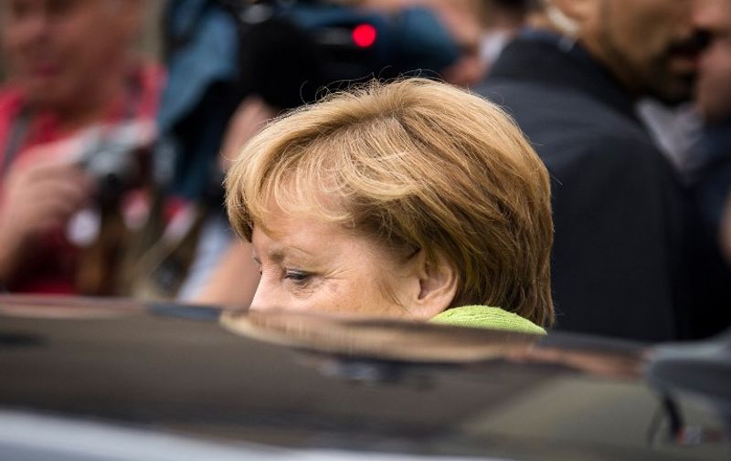 German Chancellor Angela Merkel gets into her car after visiting the Berlin-Hohenschönhausen Memorial at the site of a former prison of the East German Ministry of State Security (MfS; "Stasi") in Berlin on August 11, 2017.
Thousands of political prisoners passed through this jail, including nearly all the prominent figures who opposed the regime of the German Democratic Republic (GDR). / AFP PHOTO / AXEL SCHMIDT