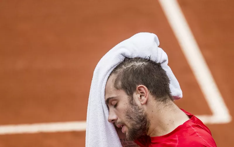 Croatia's tennis player Borna Coric wipes his sweat during the ATP World Tour Rio Open tournament semi-final match against Chile's Cristian Garin (out of frame) at the Jockey Club in Rio de Janeiro, Brazil, on February 23, 2020. (Photo by DANIEL RAMALHO / AFP) / The erroneous mention[s] appearing in the metadata of this photo by DANIEL RAMALHO has been modified in AFP systems in the following manner: [Croatia's] instead of [Serbia's]. Please immediately remove the erroneous mention[s] from all your online services and delete it (them) from your servers. If you have been authorized by AFP to distribute it (them) to third parties, please ensure that the same actions are carried out by them. Failure to promptly comply with these instructions will entail liability on your part for any continued or post notification usage. Therefore we thank you very much for all your attention and prompt action. We are sorry for the inconvenience this notification may cause and remain at your disposal for any further information you may require.