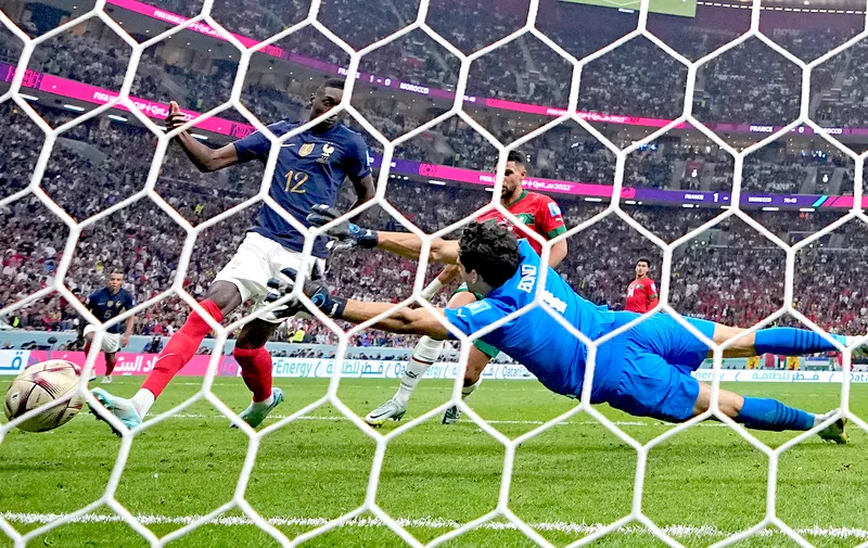 France's Randal Kolo Muani scores his side's second goal past Morocco's goalkeeper Yassine Bounou during the World Cup semifinal soccer match between France and Morocco at the Al Bayt Stadium in Al Khor, Qatar, Wednesday, Dec. 14, 2022. (AP Photo/Manu Fernandez)