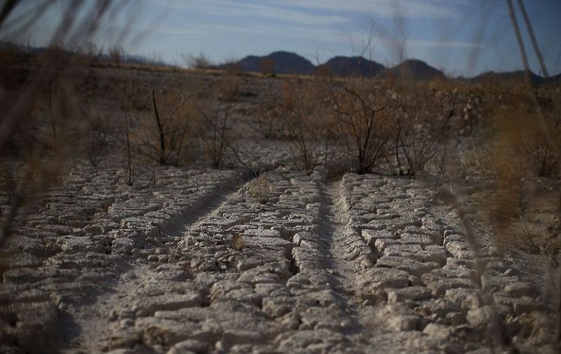 LAKE MEAD NATIONAL RECREATION AREA, NV - MAY 13: Tire tracks are visible in dry cracked earth that used to be the bottom of Lake Mead near Boulder Beach on May 13, 2015 in Lake Mead National Recreation Area, Nevada. As severe drought grips parts of the Western United States, Lake Mead, which was once the largest reservoir in the nation, has seen its surface elevation drop below 1,080 feet above sea level, its lowest level since the construction of the Hoover Dam in the 1930s.   Justin Sullivan/Getty Images/AFP