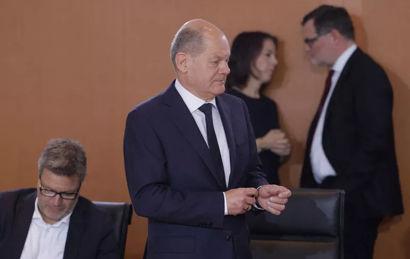 German Foreign Minister Annalena Baerbock (2nd R) and German Chief of Staff Wolfgang Schmidt (R) chat as German Chancellor Olaf Scholz (2nd L) arrives to lead the weekly cabinet meeting at the Chancellery in Berlin, Germany, on November 15, 2023; at (L) is German Minister of Economics and Climate Protection Robert Habeck. (Photo by Odd ANDERSEN / AFP)