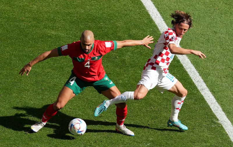 Morocco v Croatia - FIFA World Cup, WM, Weltmeisterschaft, Fussball 2022 - Group F - Al Bayt Stadium Croatia s Luka Modric right and Morocco s Sofyan Amrabat battle for the ball during the FIFA World Cup Group F match at the Al Bayt Stadium, Al Khor. Picture date: Wednesday November 23, 2022. Use subject to restrictions. Editorial use only, no commercial use without prior consent from rights holder. PUBLICATIONxNOTxINxUKxIRL Copyright: xMartinxRickettx 69913264
