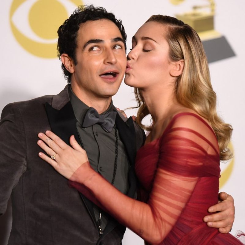 Fashion designer Zac Posen (L) and singer Miley Cyrus pose in the press room during the 60th Annual Grammy Awards on January 28, 2018, in New York. (Photo by Don EMMERT / AFP)