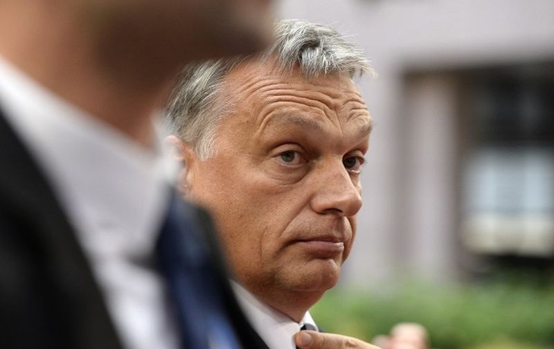 Hungary's Prime minister Viktor Orban (C) arrives to attend an European Union (EU) emergency summit on the migration crisis with a focus on strengthening external borders, at the EU Headquarters in Brussels, on September 23, 2015, a day after interior ministers agreed a deal on refugee relocation quotas.  AFP PHOTO / THIERRY CHARLIER