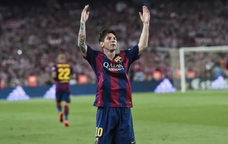 Barcelona's Argentinian forward Lionel Messi (R) celebrates his goal during the Spanish Copa del Rey (King's Cup) final football match Athletic Club Bilbao vs FC Barcelona at the Camp Nou stadium in Barcelona on May 30, 2015.   AFP PHOTO/ JOSEP LAGO