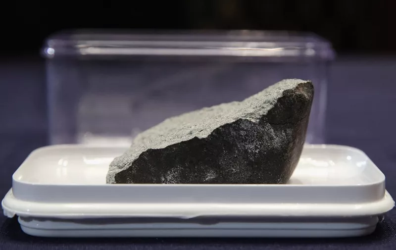 WASHINGTON, DC - JUNE 17: The Lorton Virginia Meteorite is displayed before a hearing of the House Administration Committee in the Longworth House Office Building on Capitol Hill June 17, 2015 in Washington, DC. The meteorite punched a hole in the roof of the Williamsburg Square Family Practice, a doctors office in Lorton, Viginia, on January 18, 2010.   Chip Somodevilla/Getty Images/AFP (Photo by CHIP SOMODEVILLA / GETTY IMAGES NORTH AMERICA / Getty Images via AFP)