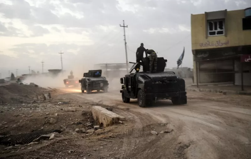 Members of the Iraqi Counter Terrorism Service (CTS) drive near the village of Bazwaya, on the eastern edges of Mosul, tightening the noose on Mosul as the offensive to retake the Islamic State group stronghold entered its third week on October 31, 2016. 


An Iraqi colonel said CTS had recaptured Bazwaya, one of two IS-held villages that had been standing between Iraqi forces and the eastern edges of Mosul.

 / AFP PHOTO / BULENT KILIC