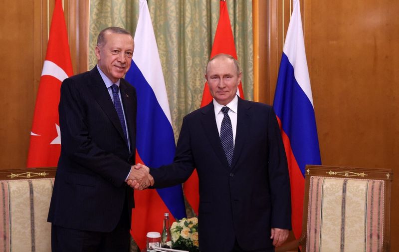 Russian President Vladimir Putin (R) shakes hands with Turkish President Recep Tayyip Erdogan (L) during a meeting in Sochi, on August 5, 2022. (Photo by Vyacheslav Prokofyev and Vyacheslav PROKOFYEV / POOL / AFP)