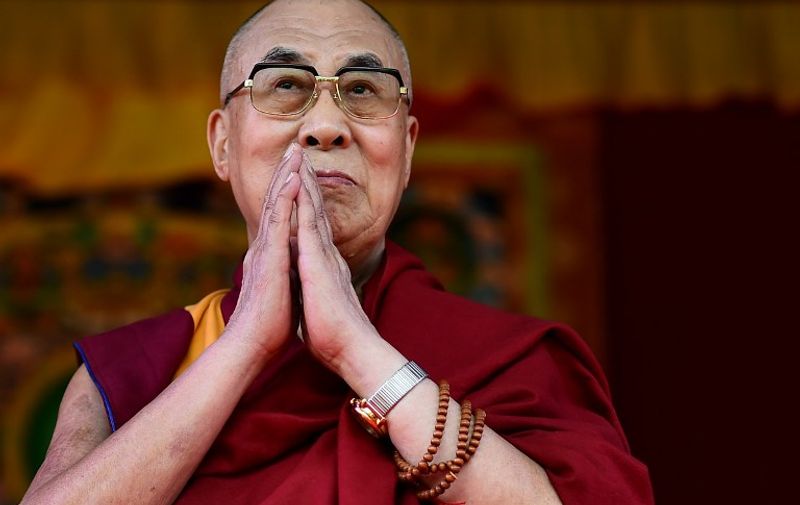 The Dalai Lama takes to the stage to address the faithful in Aldershot on June 29, 2015 which has a large Nepalese Buddhist community made up mainly of serving and retired Gurkha soldiers. 
AFP PHOTO / BEN STANSALL / AFP PHOTO / BEN STANSALL