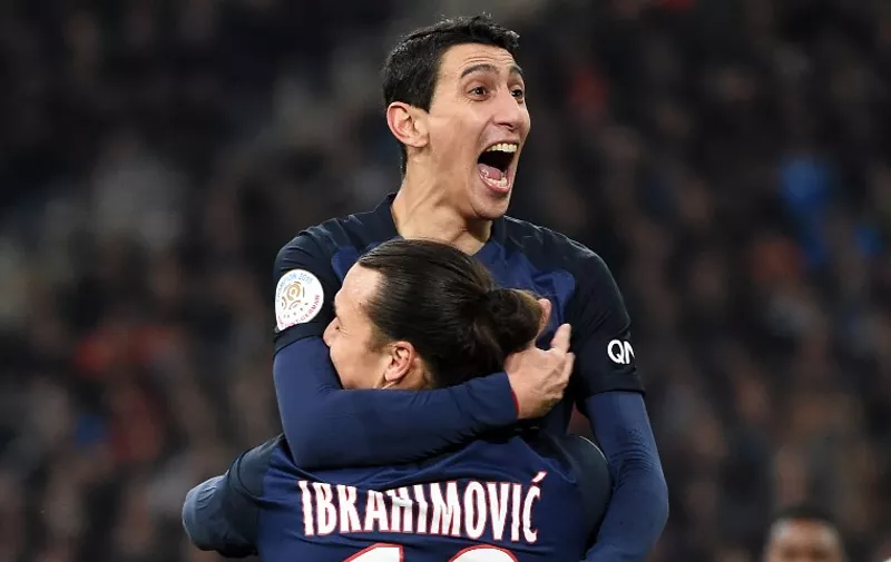 Paris Saint-Germain's Argentinian forward Angel Di Maria (TOP) celebrates with Paris Saint-Germain's Swedish forward Zlatan Ibrahimovic after scoring a goal during the French L1 football match between Marseille and Paris-Saint-Germain on February 7, 2015 at the Velodrome stadium in Marseille, southern France.  AFP PHOTO / ANNE-CHRISTINE POUJOULAT / AFP / ANNE-CHRISTINE POUJOULAT