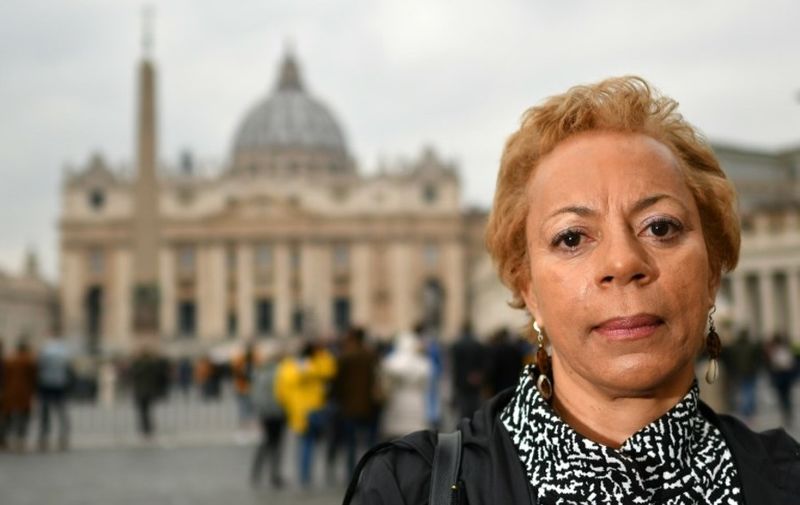 Jamaican victim of sexual abuse, Denise Buchanan, poses in front Saint Peter's square on February 18, 2019, in Rome. - "I was 17 years old when I was raped by Brother Paul," Denise Buchanan, Jamaican, explains 40 years later. Her fight to have the Catholic Church recognize her status as a victim of this Jamaican priest illustrates the isolation of many victims of sexual abuse in the clergy against the denial of justice and omerta, exacerbated in poorer countries or states where the Church remains influential in society. Denise decided to become involved by becoming a member of the steering committee of a new global network of victims, ECA (Ending Clerical Abuse). (Photo by Alberto PIZZOLI / AFP)