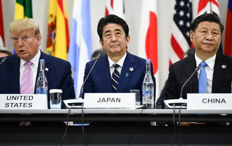 (L-R) US President Donald Trump, Japan's Prime Minister Shinzo Abe and China's President Xi Jinping attend a meeting at the G20 Summit in Osaka on June 28, 2019. (Photo by Brendan Smialowski / AFP)