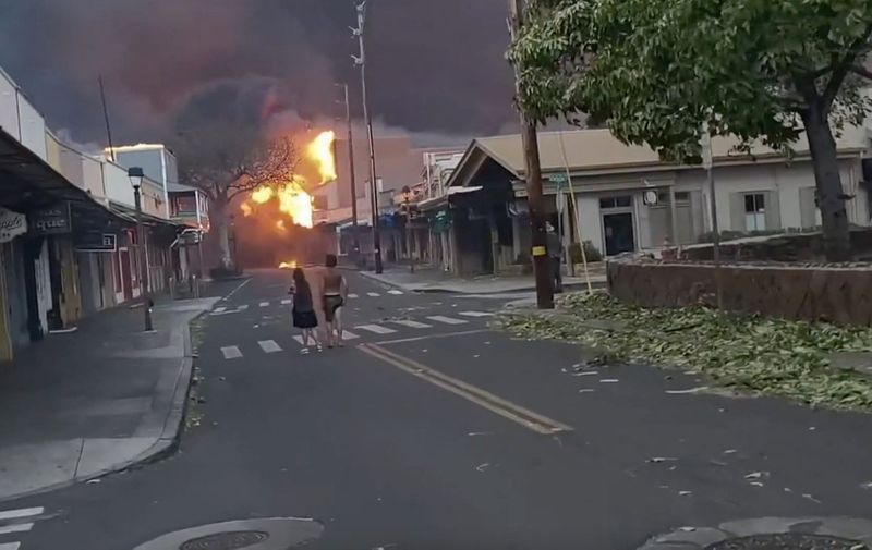 At least 36 people have died as fast-moving wildfires rage across the Hawaiian island of Maui, officials say., Residents in the Upcountry and Lahaina areas of West Maui have been forced to evacuate, with some escaping the smoke and flames by running into the ocean. Maui County officials said Tuesday that the U.S. Coast Guard was working to rescue those residents, and transported them to “safe areas.”, Maui County Mayor Richard T. Bissen issued an emergency proclamation on Tuesday, and multiple evacuation orders were in place. The county confirmed damage to structures, but did not have details on the extent of the damage., Images from video footage show the fire raging amid strong winds in the downtown business district of Lahaina - the island's main tourist area - late on Tuesday (August 8) as people watch on in horror., “Today was a devastating day in Lahaina,” Dickar said. “This is the main business district. A lot of homes nearby burned as well. Tomorrow, the sun will rise, and, through the smoke, we will all find our way. Please stay safe and help your neighbors.”, Maui County said the cause of the fires is under investigation., CREDIT A Dickar/LOCAL NEWS X /TMX/MEGA.
10 Aug 2023,Image: 795863212, License: Rights-managed, Restrictions: World Rights, Model Release: no, Pictured: Images from video footage show the fire raging amid strong winds in the downtown business district of Lahaina - the island's main tourist area - late on Tuesday (August 8) as people watch on in horror