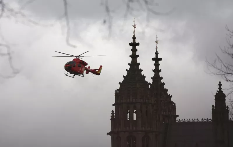 London's air ambulance arrives at the Houses of Parliament in central London on March 22, 2017 during an emergency incident.
Britain's Houses of Parliament were in lockdown on Wednesday after staff said they heard shots fired, triggering a security alert. / AFP PHOTO / DANIEL LEAL-OLIVAS