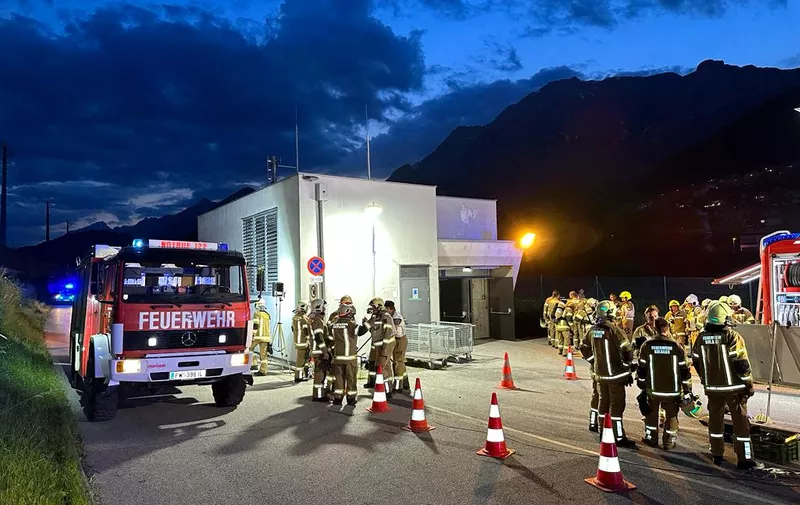 Members of the fire brigade are seen near the Terfener tunnel in Fritzens, western Austria, where a fire broke out for unknown reasons on June 7, 2023. A Nightjet train with about 200 passengers on board was in the tunnel at the time the fire broke out. No casualties were reported so far. (Photo by ZOOM.TIROL / APA / AFP) / Austria OUT