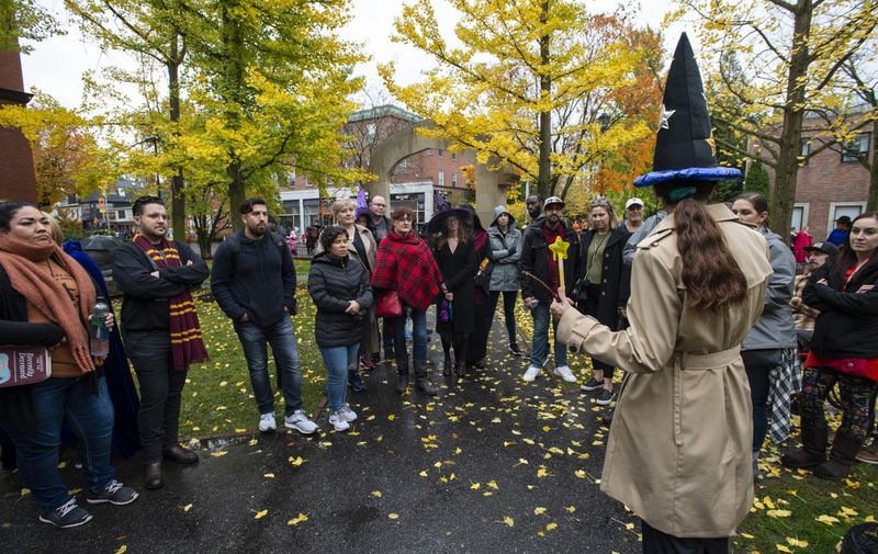 Tourist listen to a tour guide at a ghost tour during Halloween on October 31, 2019 in Salem, Massachusetts. Salem is a mecca for witches and fans of the occult, attracting thousands of visitors from around the world every year to celebrate the Halloween holiday. (Photo by Joseph Prezioso / AFP)