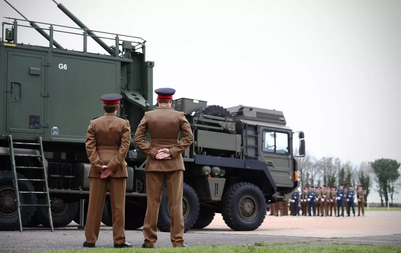 Soldiers stand stand beside the new state-of-the-art Sky Sabre air defence system at the Royal Artillery's change of colours parade at Baker Barracks, Thorney Island, southern England on January 27, 2022. - The parade marks a fairwell to the old Rapier missile system, that has been in service for nearly 50 years, and a welcome to the state-of-the-art Sky Sabre air defence system. The Sky Sabre was installed as 16 Regiment Royal Artillery's new colours. Regimental colours are ordinarily flags, used to identify regiments amidst the smoke on the battlefield. In the case of The Royal Artillery, their guns were their most cherished asset - never to fall into the hands of the enemy. (Photo by ADRIAN DENNIS / AFP)
