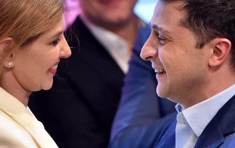 Ukrainian comedian and presidential candidate Volodymyr Zelensky looks at his wife Olena after the announcement of the first exit poll results in the second round of Ukraine's presidential election at his campaign headquarters in Kiev on April 21, 2019. (Photo by Sergei GAPON / AFP)