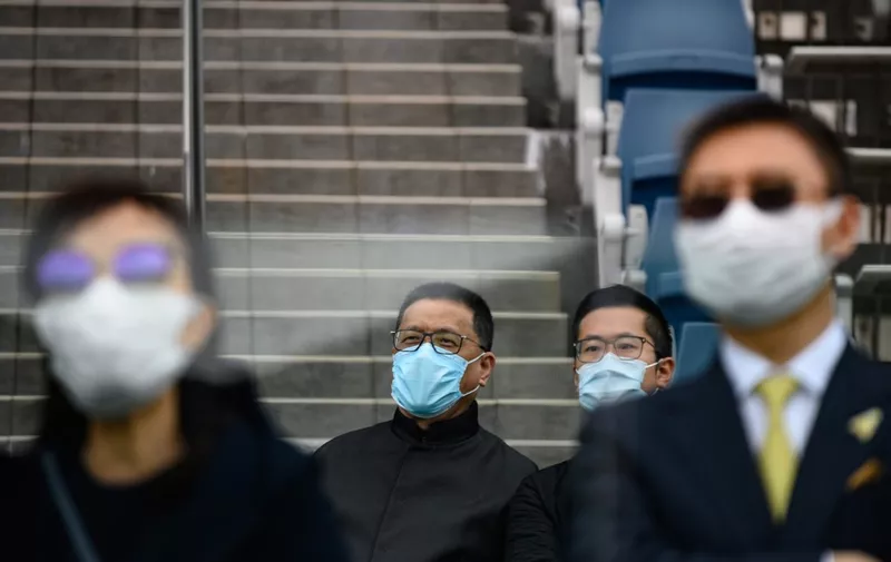 Horse owners and their guests wear face masks as a preventative measure against the COVID-19 coronavirus, as they watch the races during the Hong Kong Gold Cup day at the Sha Tin racecourse on February 16, 2020. - The number of new cases from China's coronavirus epidemic dropped for a third consecutive day on Sunday, as the World Health Organisation chief warned it was "impossible" to predict how the outbreak would develop. (Photo by Philip FONG / AFP)