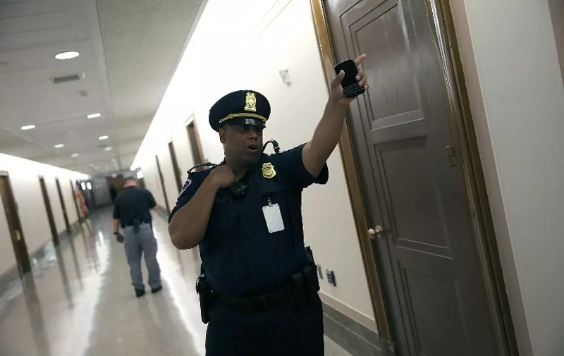 WASHINGTON, DC - JUNE 09: U.S. Capitol Hill police direct members of the public away from an office where a suspicious package was identified near where the Senate Homeland Security and Governmental Affairs Committee was holding a hearing in the Dirksen Senate Office Building June 9, 2015 in Washington, DC. Several floors of the Senate office building were evcauated after a call about a suspicious package. The committee heard testimony on "Oversight of the Transportation Security Administration: First-Hand and Government Watchdog Accounts of Agency Challenges."   Win McNamee/Getty Images/AFP