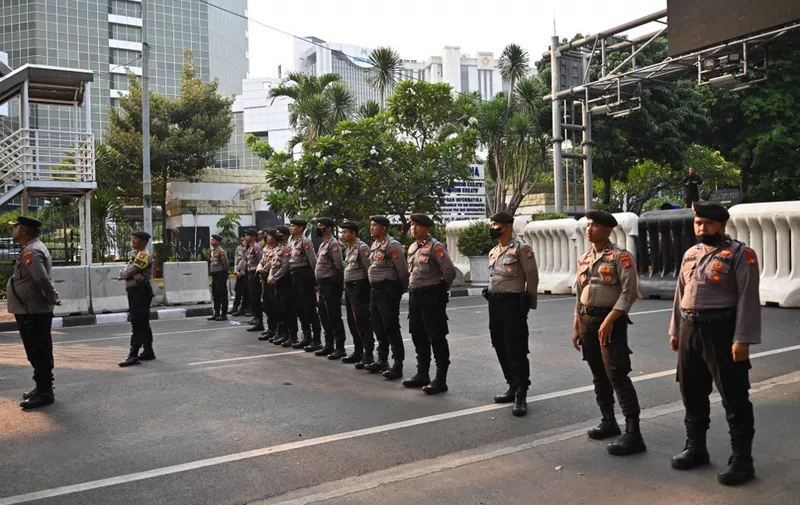 Indonesian police stand guard during a protest against the decision of Indonesia's constitutional court adjusting the age eligibility for presidential candidacy that led to Gibran Rakabuming Raka, son of President Joko Widodo, to be the vice presidential running mate with Defence Minister Prabowo Subianto, in Jakarta on October 26, 2023. (Photo by ADEK BERRY / AFP)