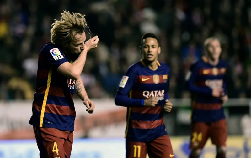 Barcelona's Croatian midfielder Ivan Rakitic celebrates after scoring during the Spanish league football match CF Rayo Vallecano vs FC Barcelona at the Vallecas stadium in Madrid on March 3, 2016. / AFP / PIERRE-PHILIPPE MARCOU