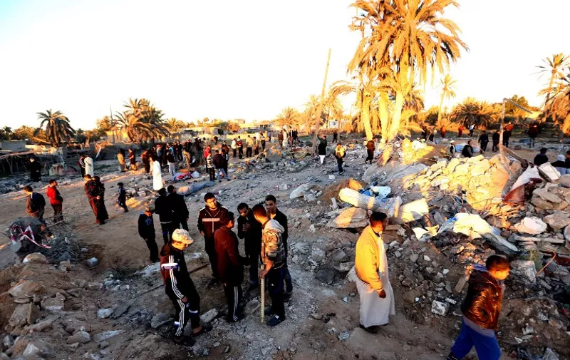 Libyans gather next to debris at the site of a jihadist training camp, targeted in a US air strike, near the Libyan city of Sabratha on February 19, 2016.

A US air strike on a jihadist training camp in Libya killed dozens of people Friday, probably including a senior Islamic State group operative behind attacks in Tunisia, officials said. / AFP / MAHMUD TURKIA