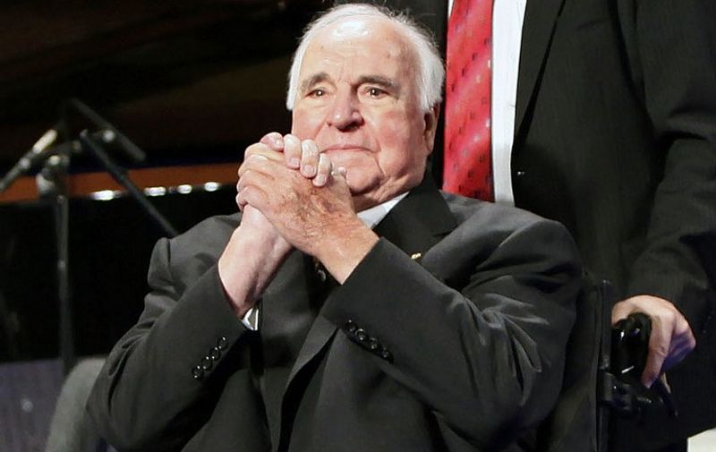 (FILES) This file picture taken on October 31, 2009 shows former German Chancellor Helmut Kohl attending a commemorative event on the fall of the wall at the Friedrichstadtpalast music hall in Berlin. 
Former Chancellor Helmut Kohl said that Europe could "become a new homeland" for migrants and criticized the German government's refugee policy in the preface to one of his books, according to the Tagesspiegel newspaper on April 16, 2016. / AFP PHOTO / DAVID GANNON