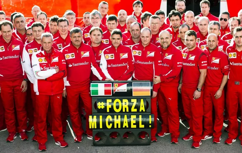 RE-CROP VERSION - This handout picture released on January 27, 2014 by the Ferrari Press Office shows the team Ferrari posing in Jerez de la Frontera in support of German Formula One driver Michael Schumacher, who remains in a coma following a serious skiing accident last month. The 45-year-old has been in a medically-induced coma since suffering the accident when skiing off-piste in the French ski resort of Meribel on December 29.    RESTRICTED TO EDITORIAL USE - MANDATORY CREDIT "AFP PHOTO / FERRARI PRESS OFFICE" - NO MARKETING NO ADVERTISING CAMPAIGNS - DISTRIBUTED AS A SERVICE TO CLIENTS / AFP / FERRARI PRESS OFFICE / -