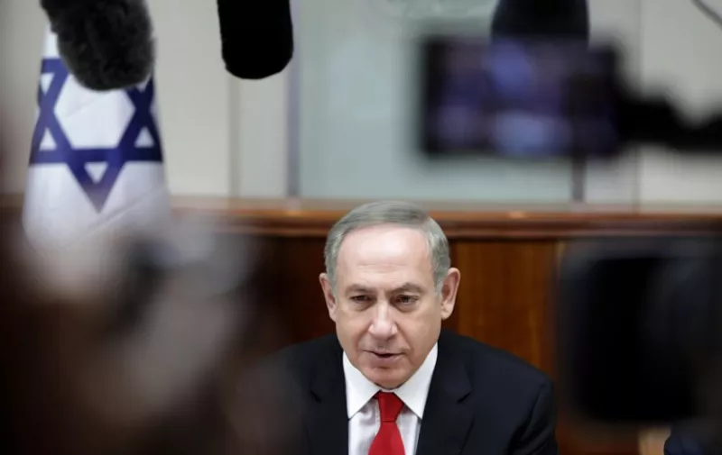 Israeli Prime Minister Benjamin Netanyahu chairs the weekly cabinet meeting in Jerusalem on February 5, 2017. / AFP PHOTO / AP AND POOL / Dan Balilty