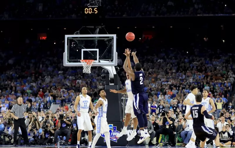 HOUSTON, TEXAS - APRIL 04: Kris Jenkins #2 of the Villanova Wildcats shoots the game-winning three pointer to defeat the North Carolina Tar Heels 77-74 in the 2016 NCAA Men's Final Four National Championship game at NRG Stadium on April 4, 2016 in Houston, Texas.   Ronald Martinez/Getty Images/AFP