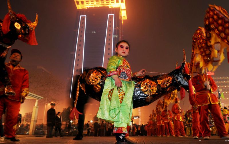 WUHAN, CHINA - FEBRUARY 9: (CHINA OUT) A child waits to perform a dance to celebrate the Lantern Festival on February 9, 2009 in Wuhan of Hubei Province, The Lantern Festival is a Chinese festival celebrated on the fifteenth day of the first month in the lunar new year in the Chinese calendar, an Ox year this year, marking the official end to new year celebrations. (Photo by China Photos/Getty Images)