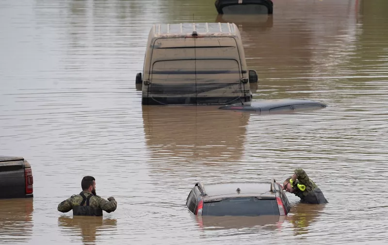 Soldiers of the German armed forces Bundeswehr search for flood victims in submerged vehicles on the federal highway B265 in Erftstadt, western Germany, on July 17, 2021, after heavy rains hit parts of the country, causing widespread flooding and major damage. - Rescue workers scrambled on July 17 to find survivors and victims of the devastation wreaked by the worst floods to hit western Europe in living memory, which have already left more than 150 people dead and dozens more missing. (Photo by SEBASTIEN BOZON / AFP)