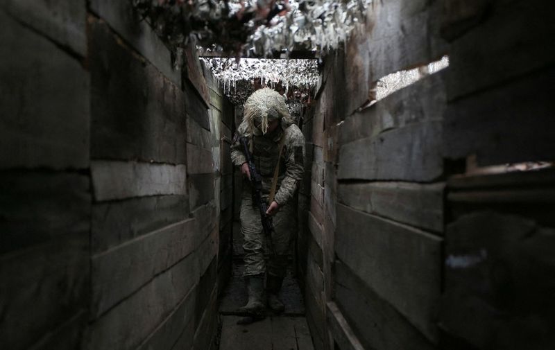 Ukrainian soldier walks along a trench on the frontline with Russia-backed separatists, not far from town of Avdiivka, Donetsk region, on December 10, 2021. (Photo by Anatolii STEPANOV / AFP)