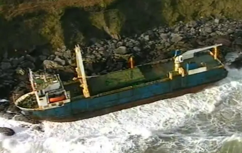 A handout still image take from footage released by the Irish Coast Guard on February 17, 2020 and recorded on February 16, 2020 shows the abandoned MV Alta cargo ship on the rocks off the coast of Ballycotton near Cork in Ireland. - A "ghost ship" drifting without a crew for more than a year washed ashore on Ireland's south coast in high seas caused by Storm Dennis, the Republic's coast guard said on February 17. The abandoned 77-metre (250-feet) cargo ship the MV Alta ran aground on rocks outside the village of Ballycotton near Cork, Ireland's second city, bringing an end to her months-long voyage. The Alta's odyssey began in September 2018 when she became disabled in the mid-Atlantic en route from Greece to Haiti. (Photo by - / IRISH COAST GUARD / AFP) / RESTRICTED TO EDITORIAL USE - MANDATORY CREDIT "AFP PHOTO / IRISH COAST GUARD " - NO MARKETING - NO ADVERTISING CAMPAIGNS - DISTRIBUTED AS A SERVICE TO CLIENTS