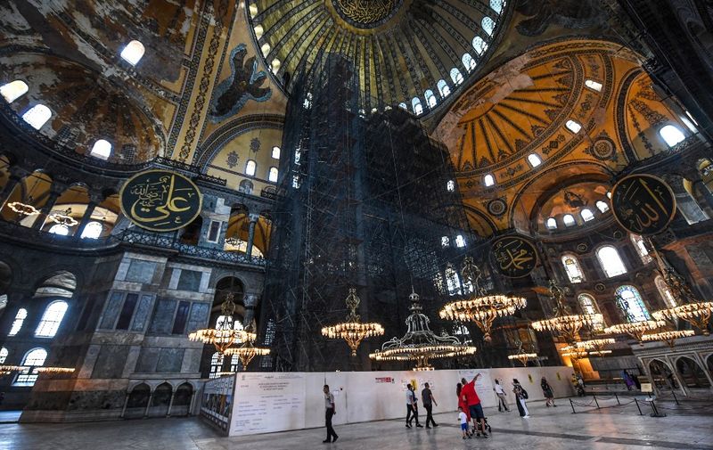 People visit the Hagia Sophia museum in Istanbul, on July 10, 2020. - Turkey's top court considered whether Istanbul's emblematic landmark and former cathedral Hagia Sophia can be redesignated as a mosque, a ruling which could inflame tensions with the West. (Photo by Ozan KOSE / AFP)
