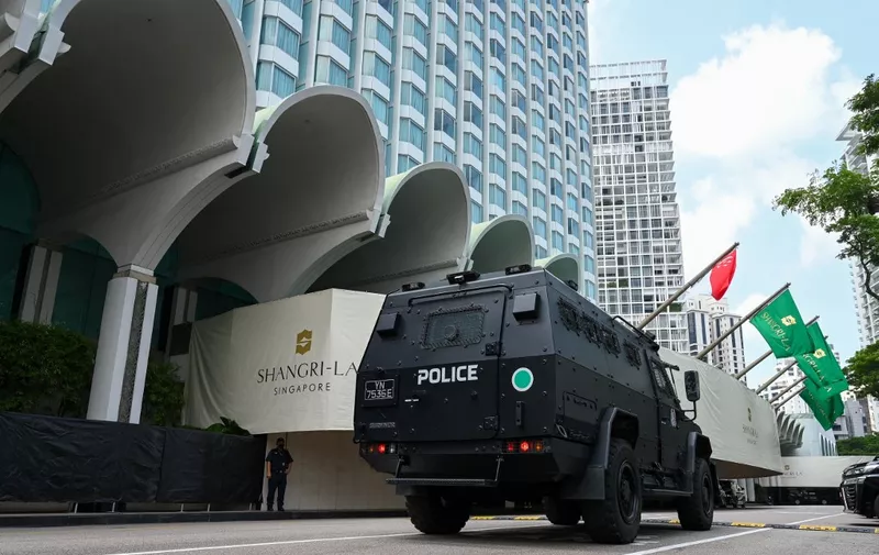 A police vehicle drives past the venue of the Shangri-La Dialogue summit in Singapore on June 10, 2022. (Photo by Roslan RAHMAN / AFP)