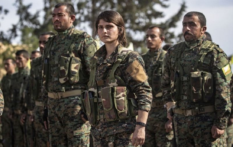 Fighters of the US-backed Kurdish-led Syrian Democratic Forces (SDF) take part in a parade to celebrate near the Omar oil field in the eastern Syrian Deir Ezzor province on March 23, 2019, after announcing the total elimination of the Islamic State (IS) group's last bastion in eastern Syria. - Kurdish-led forces pronounced the death of the Islamic State group's nearly five-year-old "caliphate" early on March 23 after flushing out diehard jihadists from their very last bastion in eastern Syria. In Al-Omar, an oil field used as the main SDF staging base for the final phase of the assault, fighters in their best fatigues laid down their weapons and broke into song and dance. (Photo by Delil souleiman / AFP)