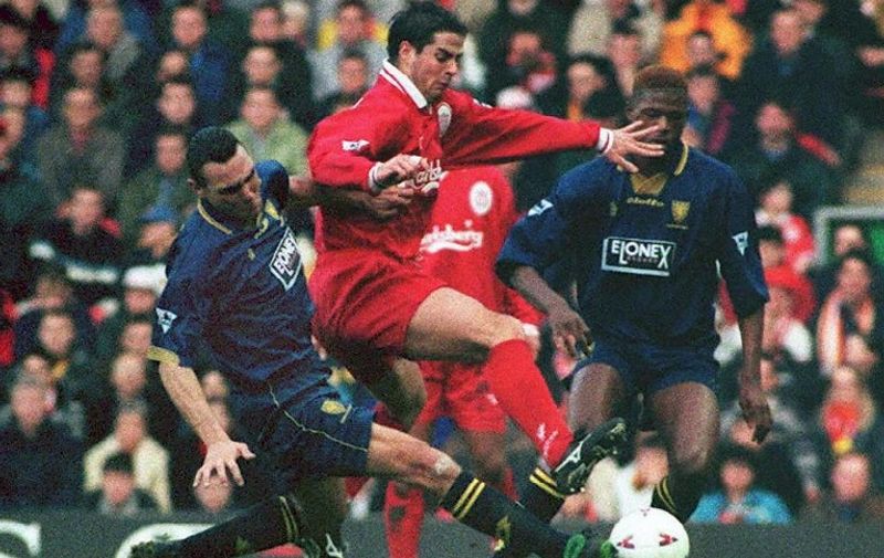 Wimbledon's Vinnie Jones (L) tackles Liverpool's Jamie Redknapp during their Premiership clash at Anfield. Liverpool defeated WImbledon 2-0. UK   OUT / AFP PHOTO / PA / STR