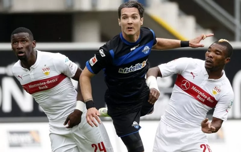 Stuttgart's defender Antonio Ruediger (L) and Paderborn's Srdjan Lakic (C) vies for the ball during the German first division Bundesliga football match between SC Paderborn and VfB Stuttgart at the Benteler Arena in Paderborn, western Germany, on May 23, 2015. AFP PHOTO / NORBERT SCHMIDT

RESTRICTIONS - DFL RULES TO LIMIT THE ONLINE USAGE DURING MATCH TIME TO 15 PICTURES PER MATCH. IMAGE SEQUENCES TO SIMULATE VIDEO IS NOT ALLOWED AT ANY TIME. FOR FURTHER QUERIES PLEASE CONTACT DFL DIRECTLY AT + 49 69 650050. / AFP / NORBERT SCHMIDT